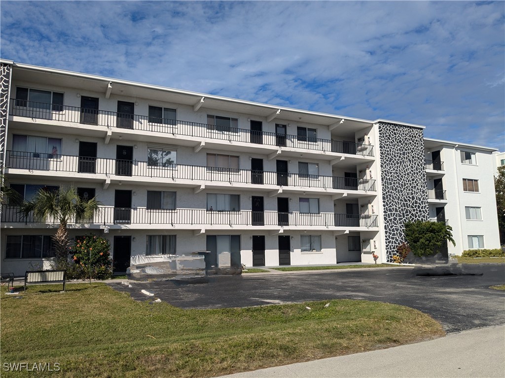 a view of building with yard in front of it