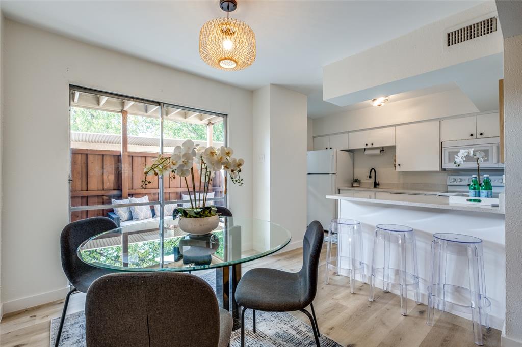 a dining room with furniture a chandelier and wooden floor