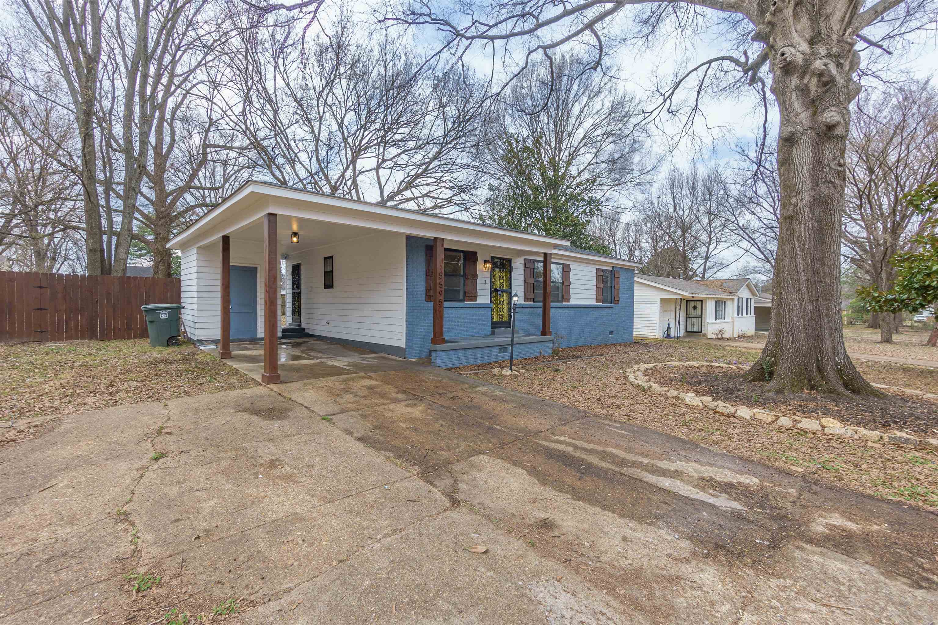 a view of a house with a yard covered in snow