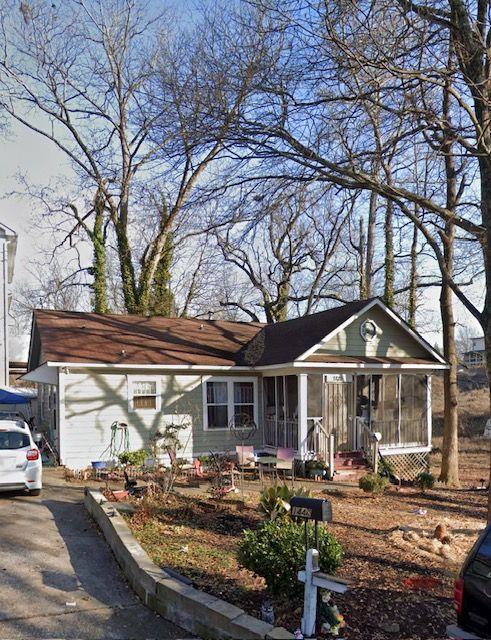 a front view of house with yard outdoor seating and barbeque oven