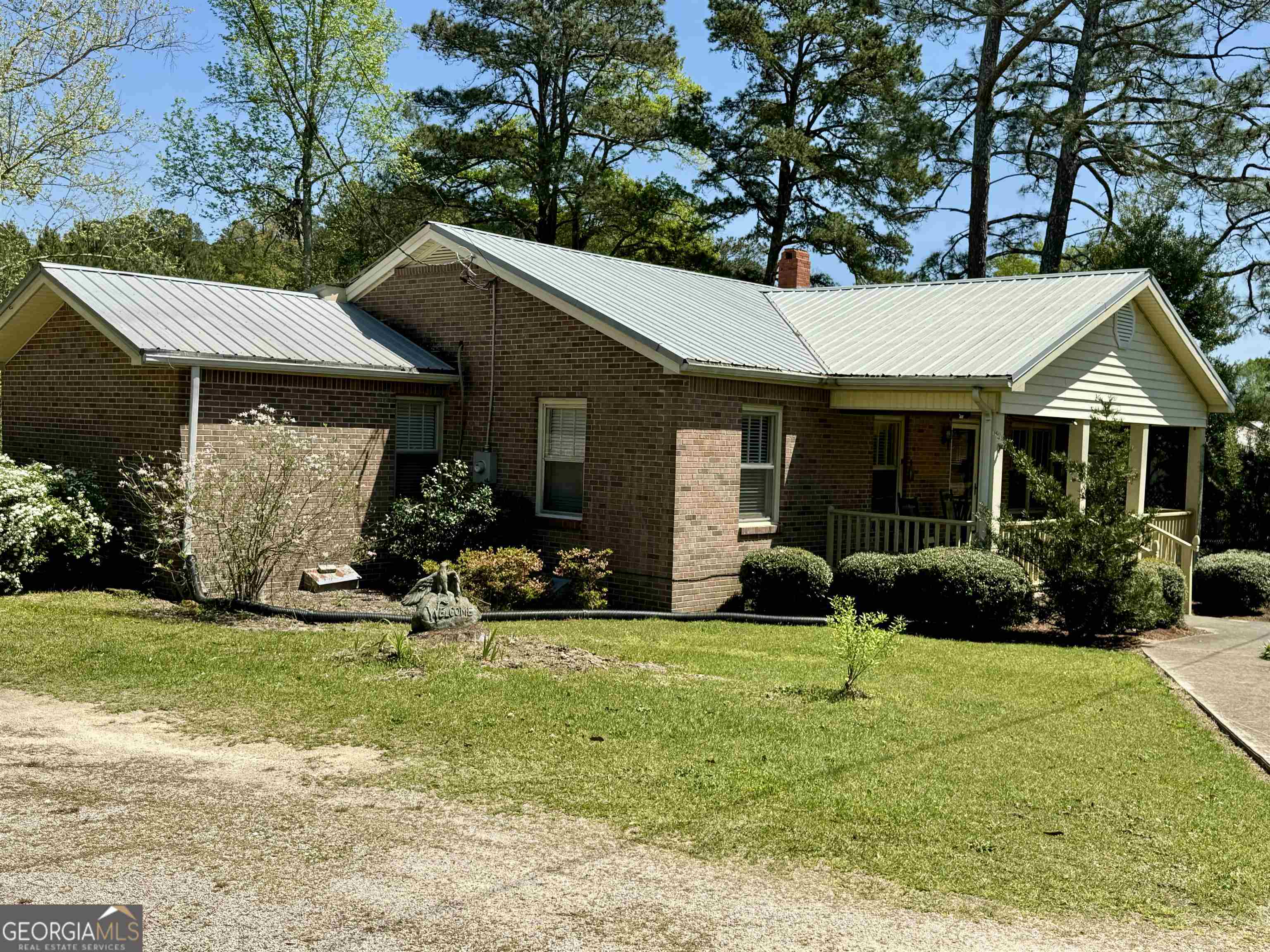 a view of a house with yard and sitting area