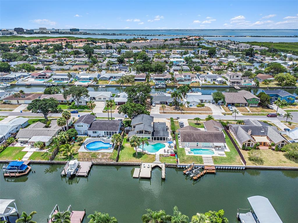 an aerial view of a houses with a lake