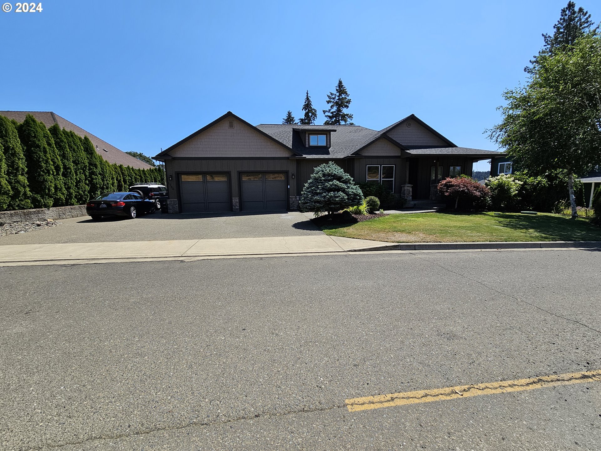 a front view of a house with a yard and a garage