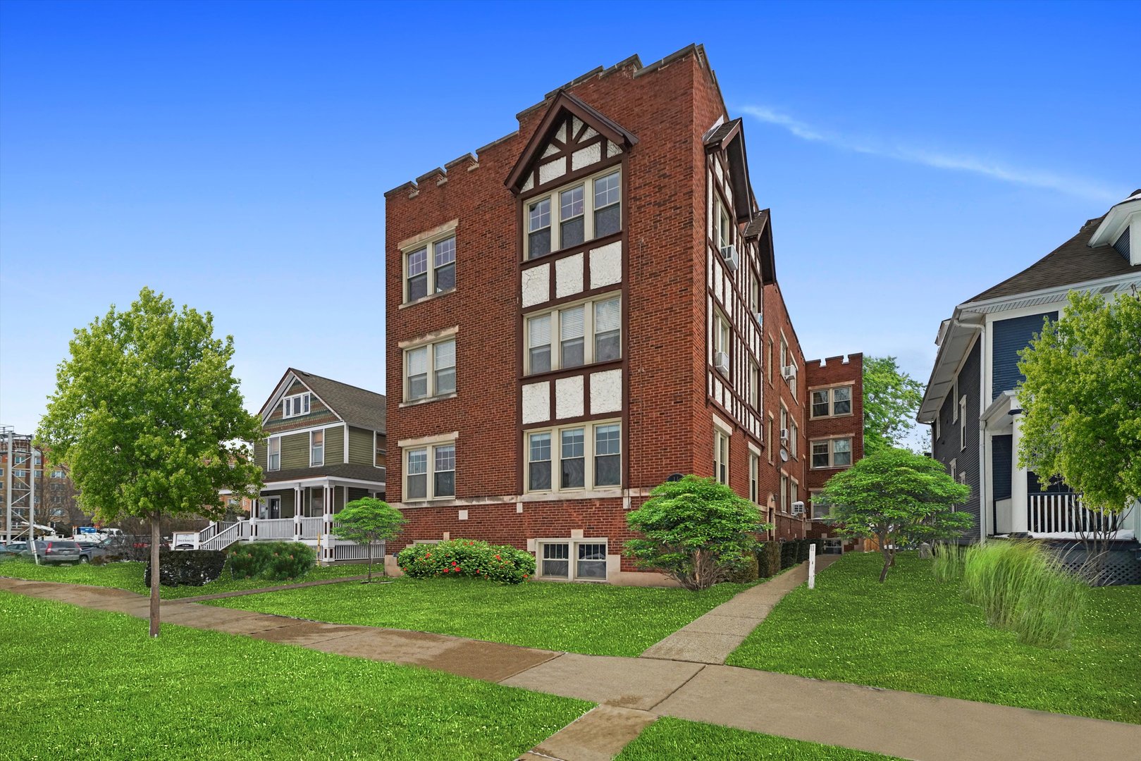 a view of a brick building next to a yard