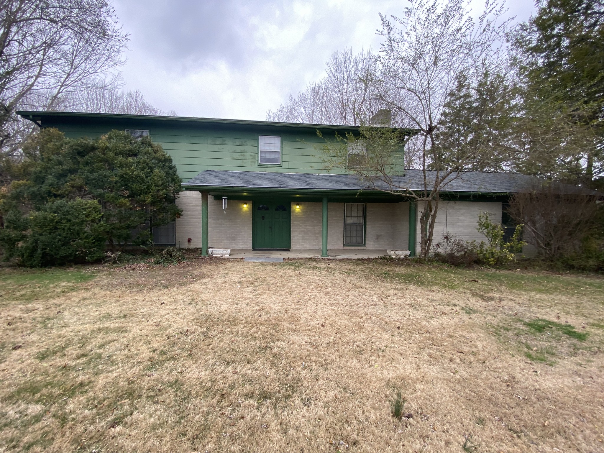 a front view of a house with a garden