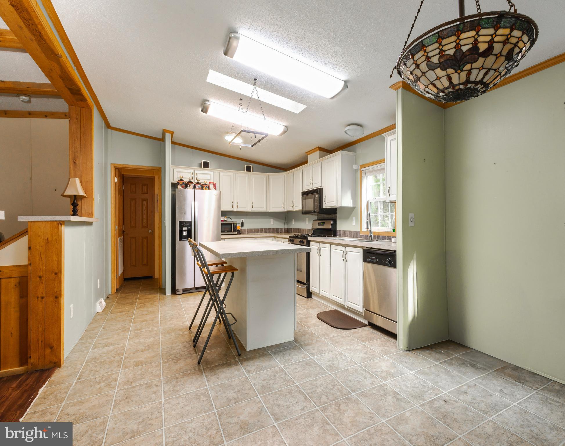 a kitchen with a sink cabinets and refrigerator