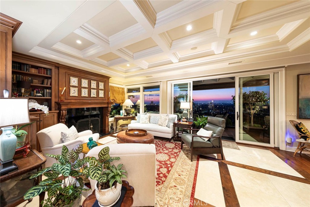 a living room with fireplace furniture and a floor to ceiling window