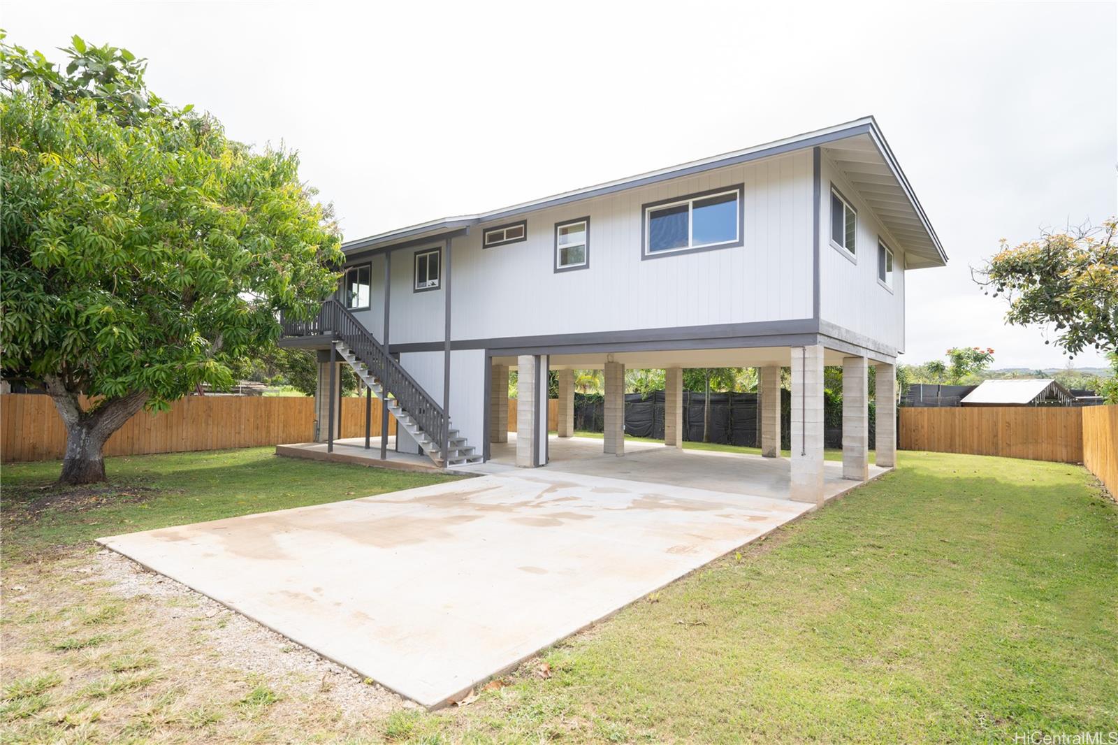 a view of house with backyard and glass windows