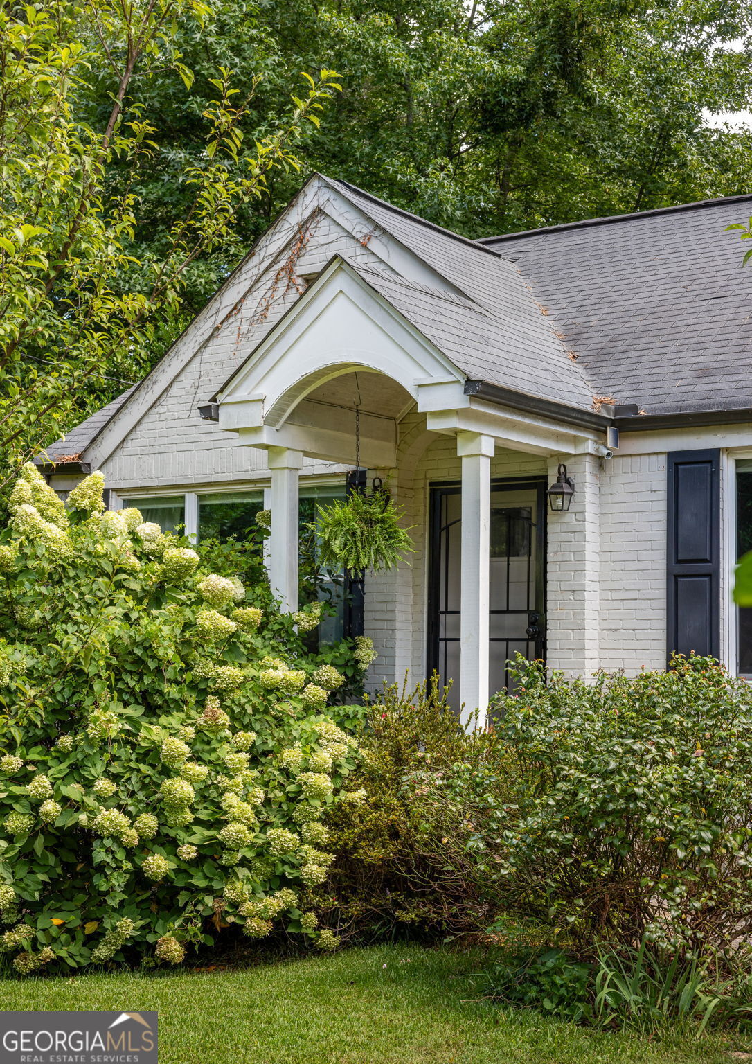 a front view of a house with garden