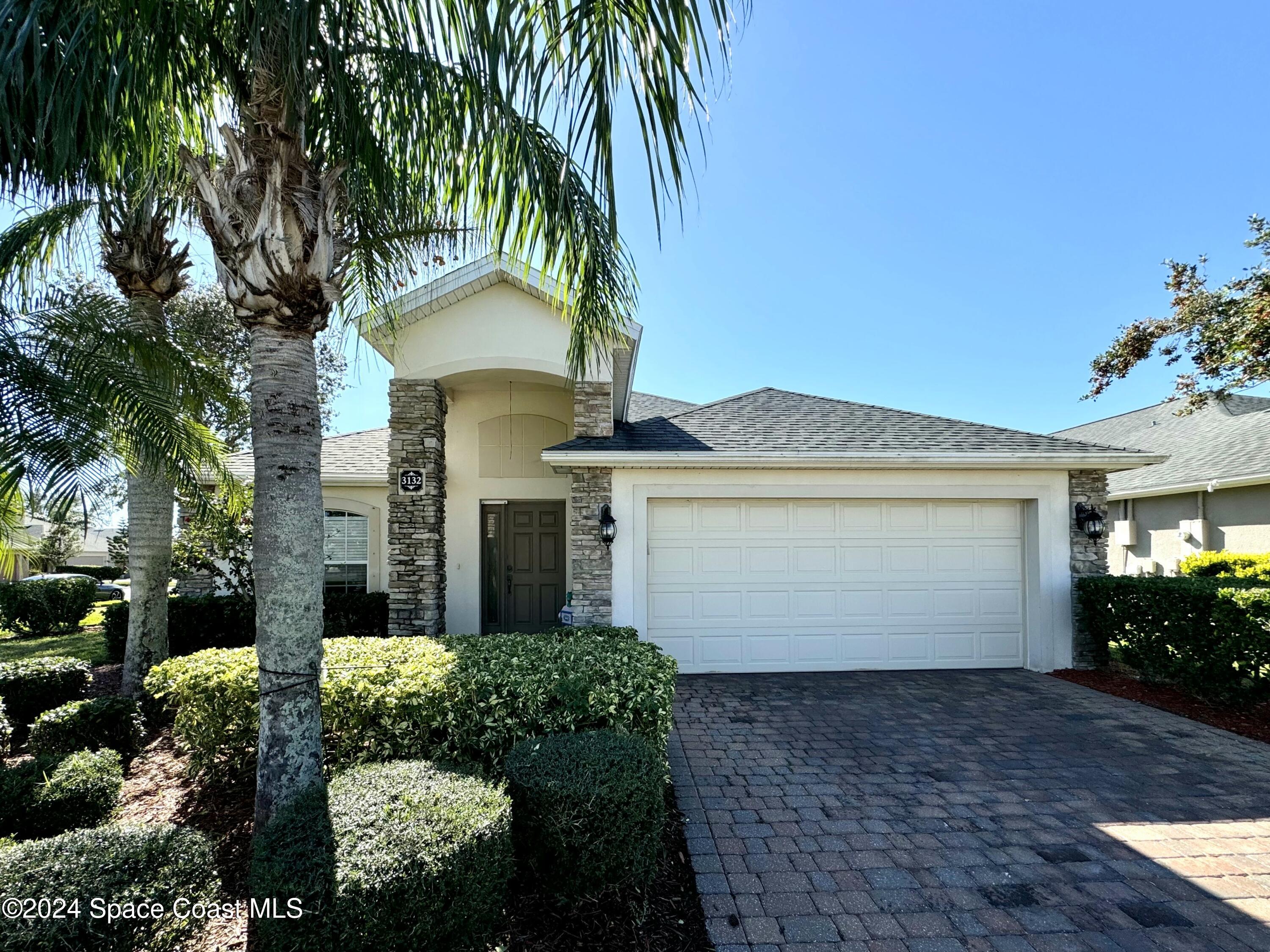 a front view of a house with a garage