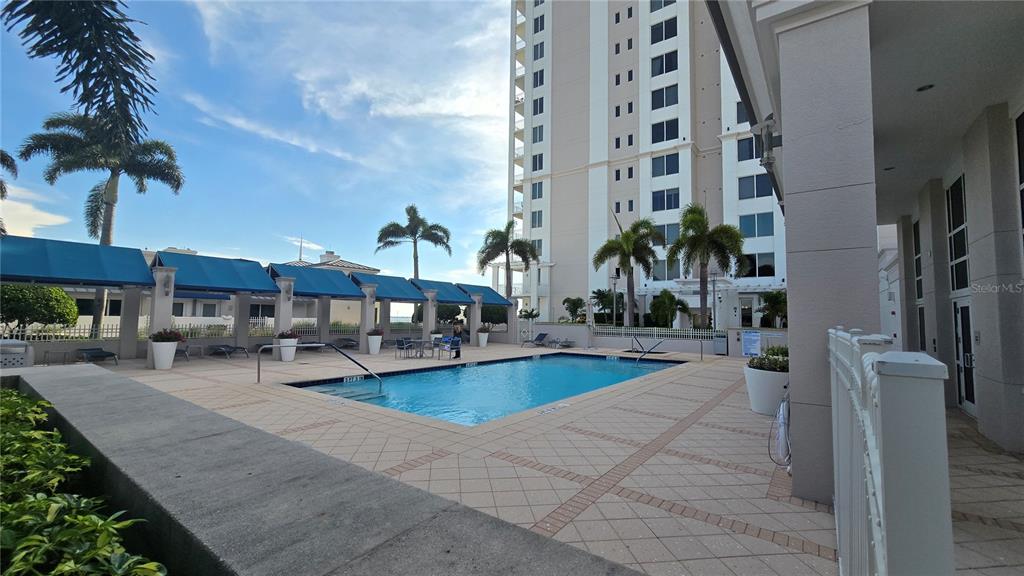 a view of a swimming pool with outdoor seating