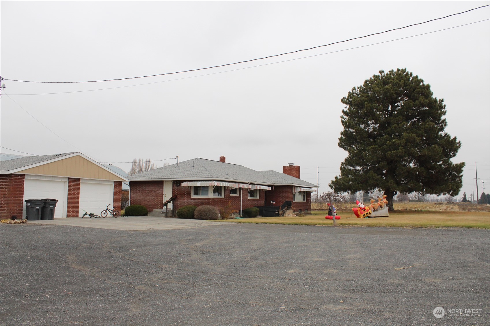 a front view of a house with a road