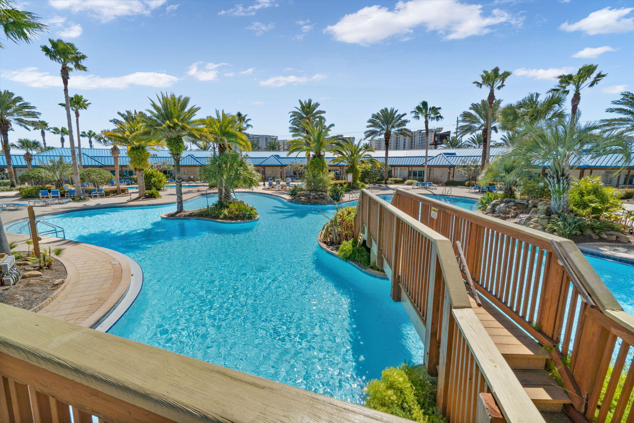 a view of a swimming pool with a patio and garden