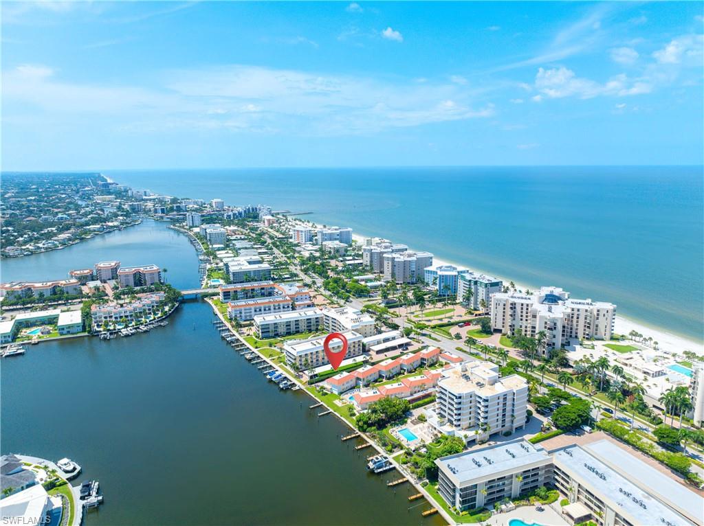 Birds eye view of property with a water view