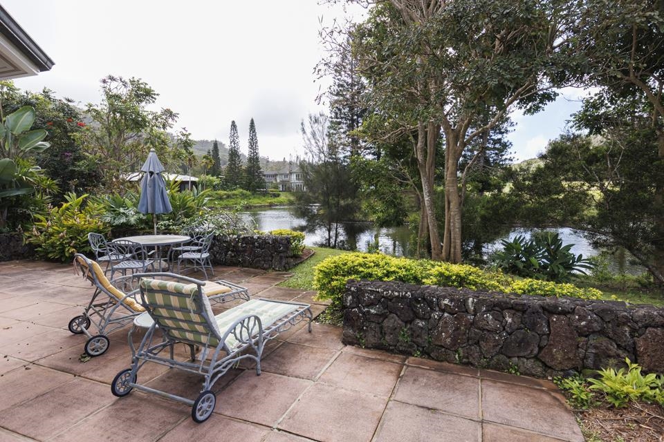 a view of a backyard with furniture and a garden