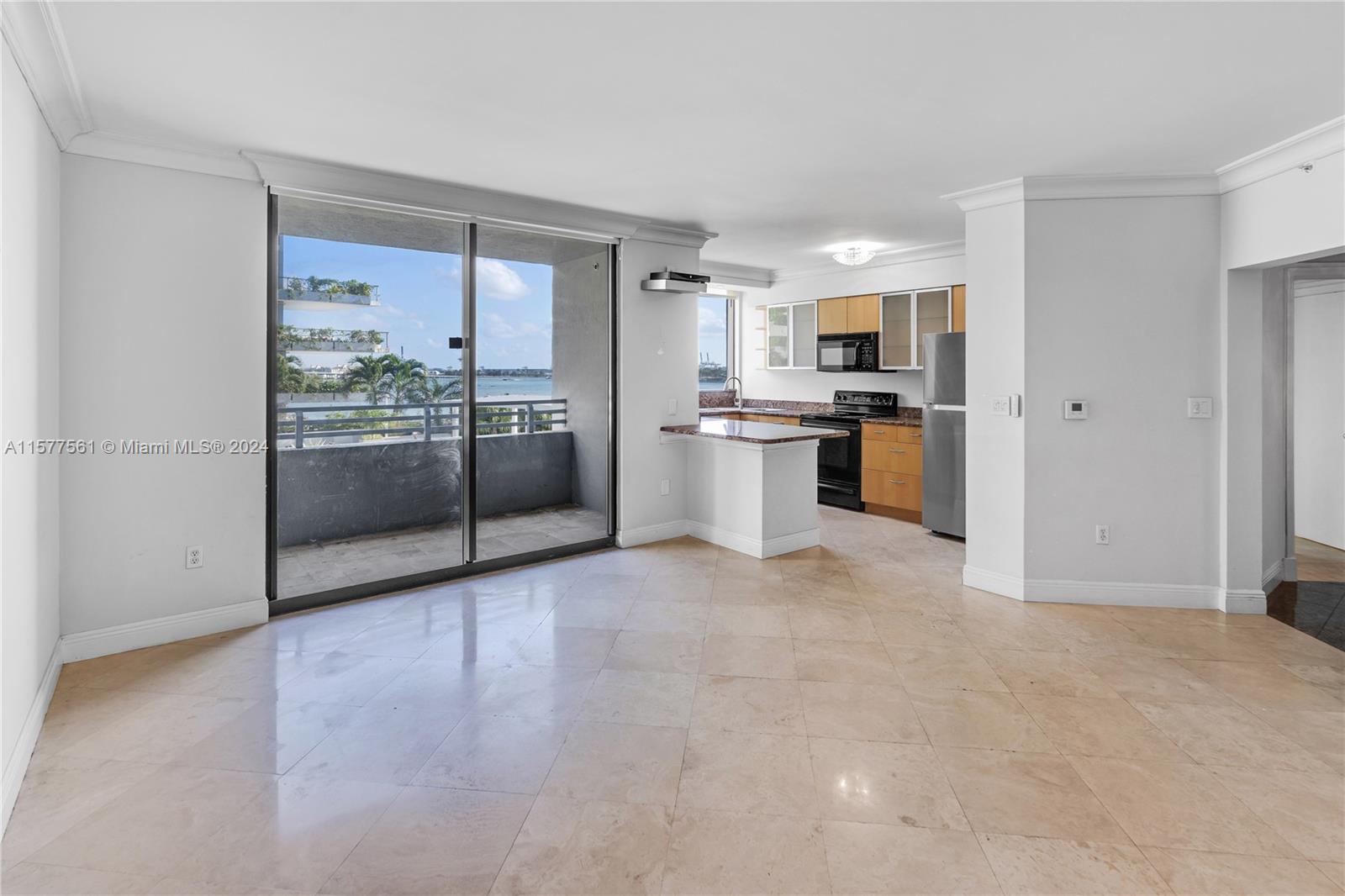 a large white kitchen with stainless steel appliances granite countertop a refrigerator and a stove top oven