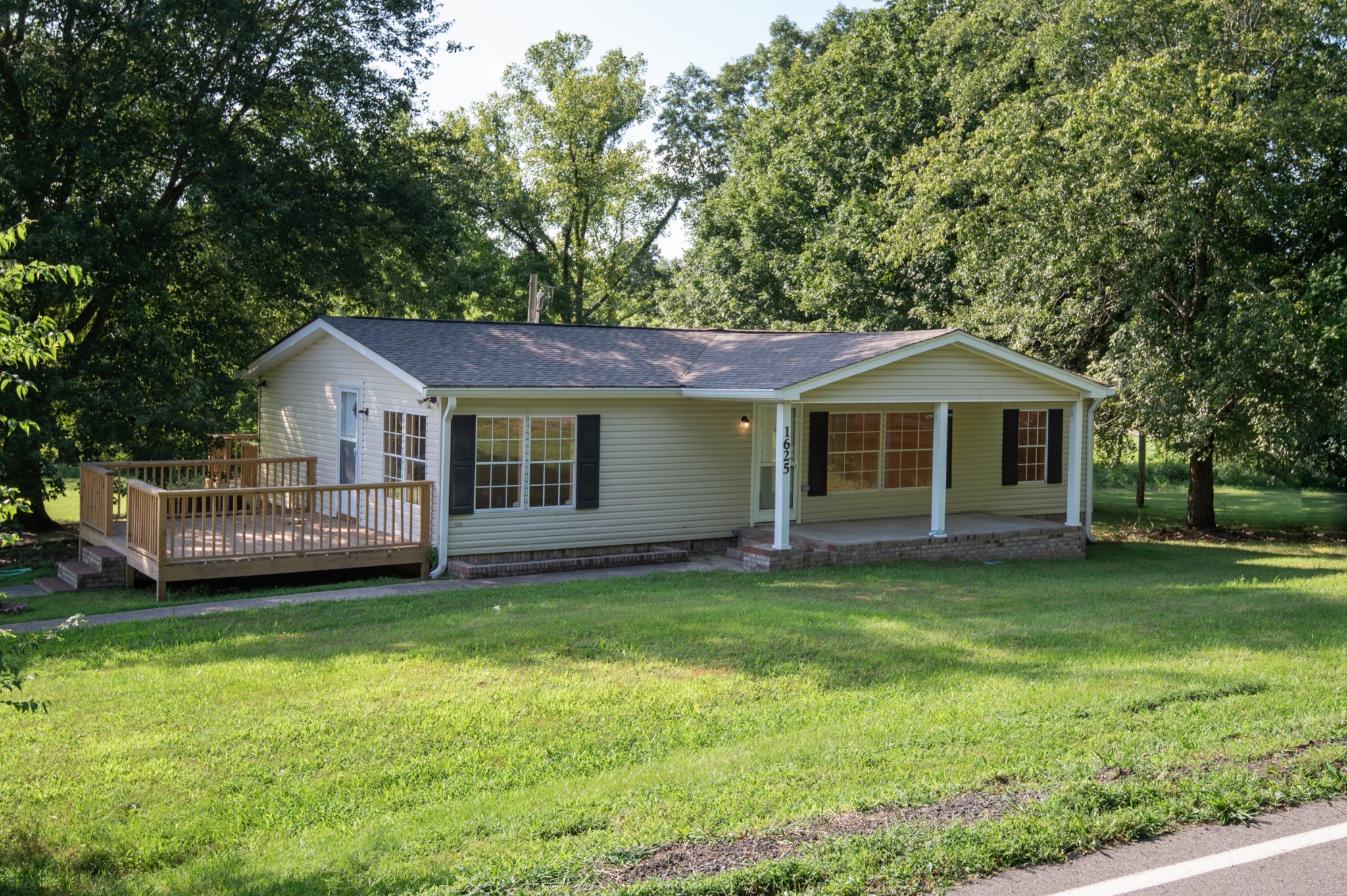 a view of a house with a yard and sitting area