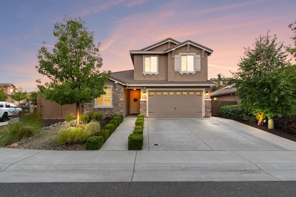 a front view of a house with a yard and garage