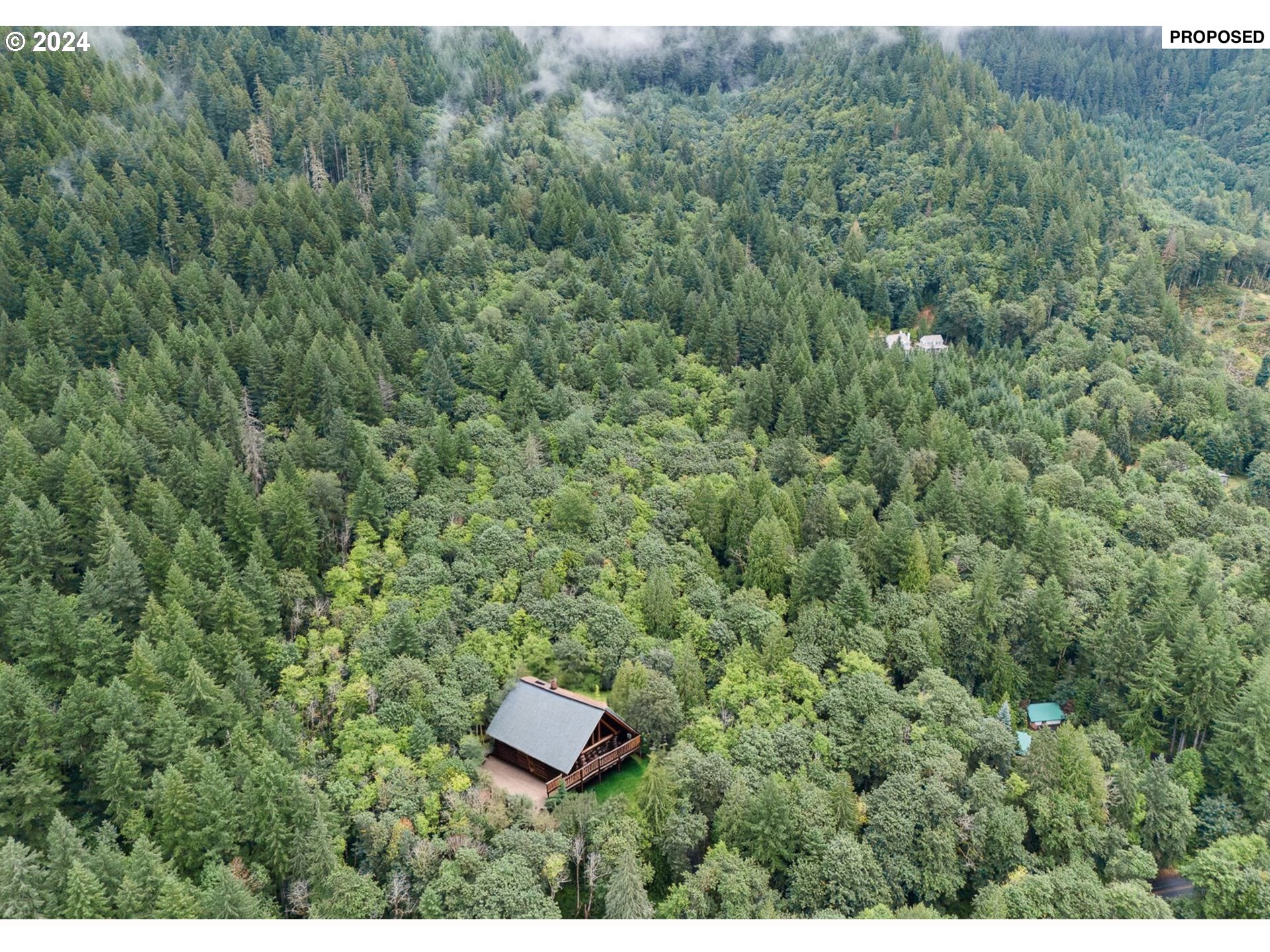 a view of a wooden house with a yard