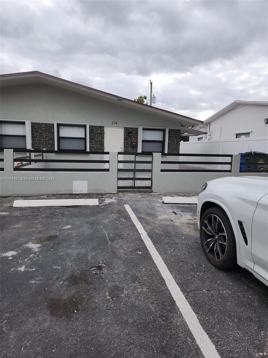 a view of garage and car parked