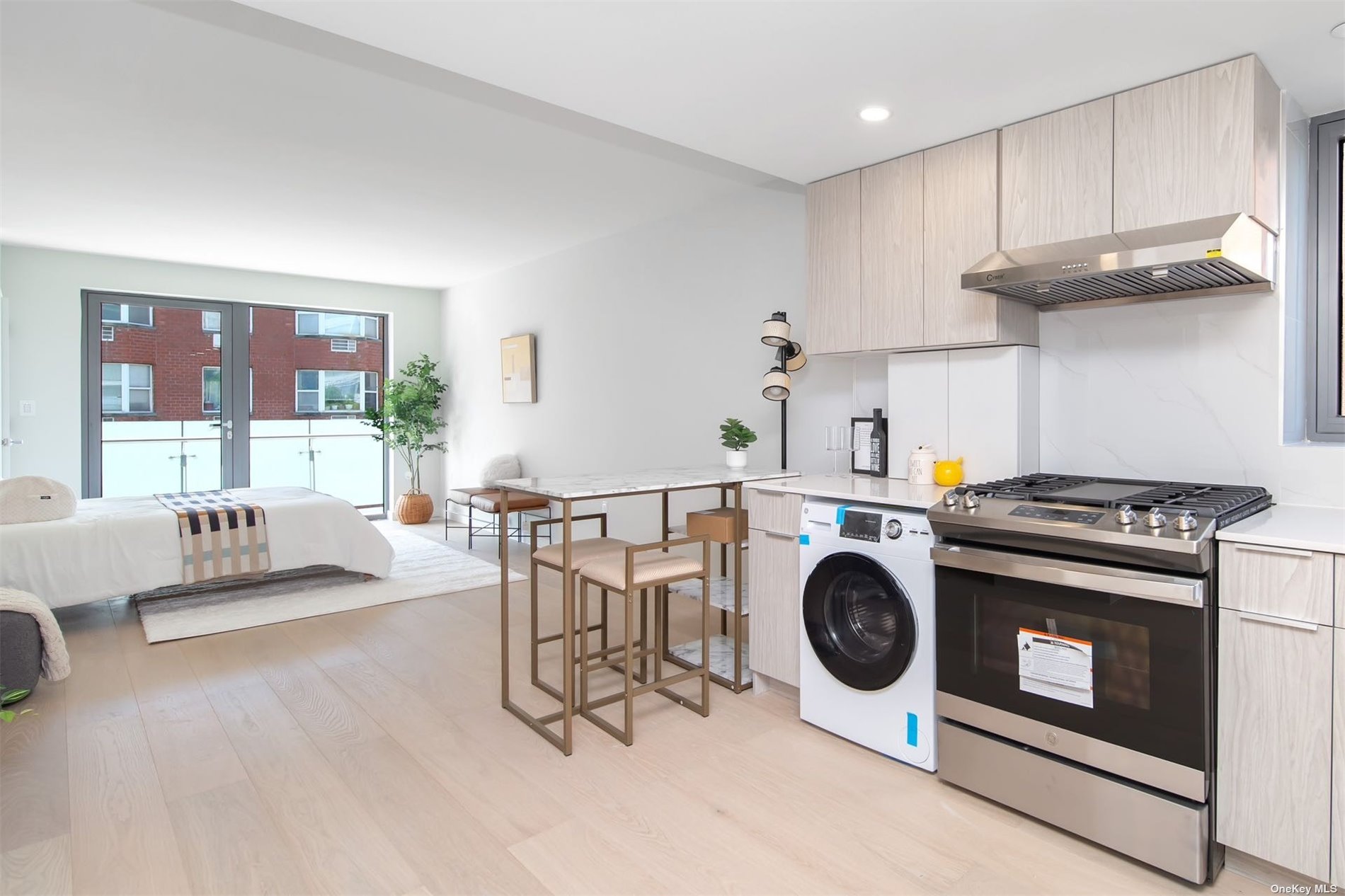 a kitchen with a stove a microwave and wooden floors