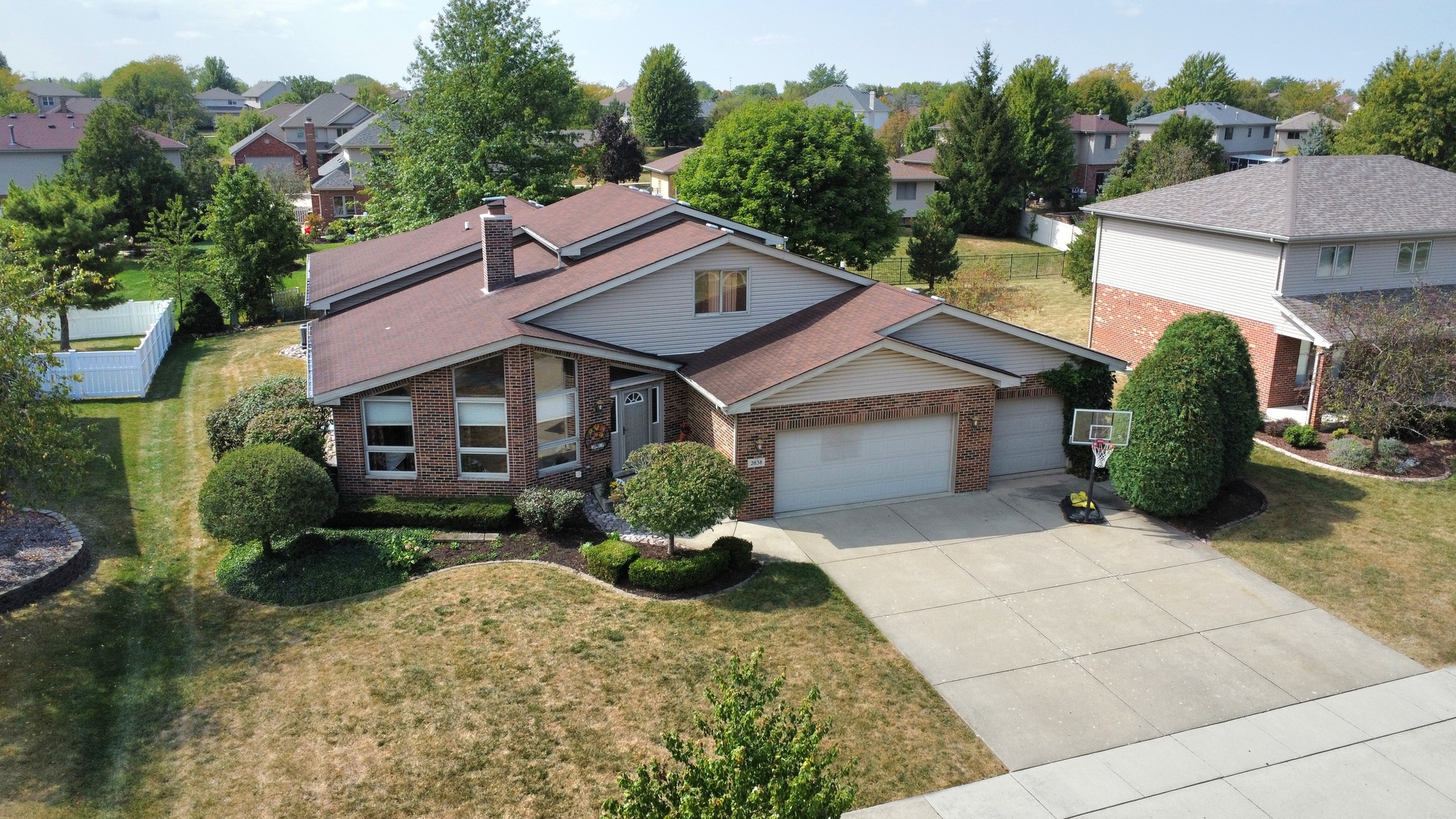 a front view of a house with a yard and potted plants