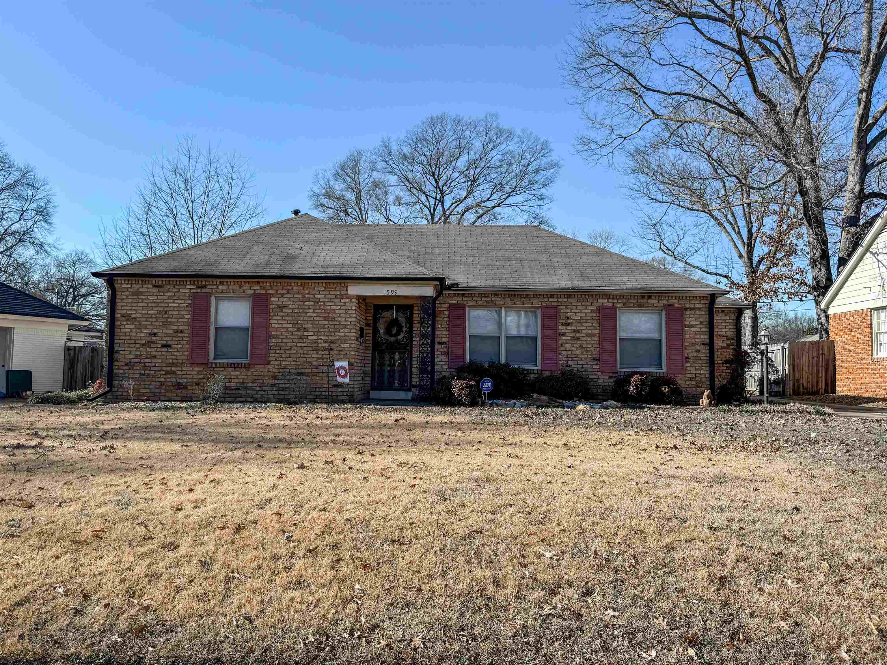 Single story home with a front lawn