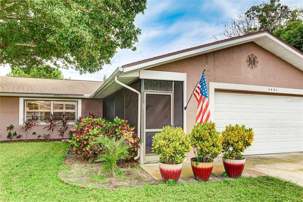 a front view of a house with a yard garage and a yard