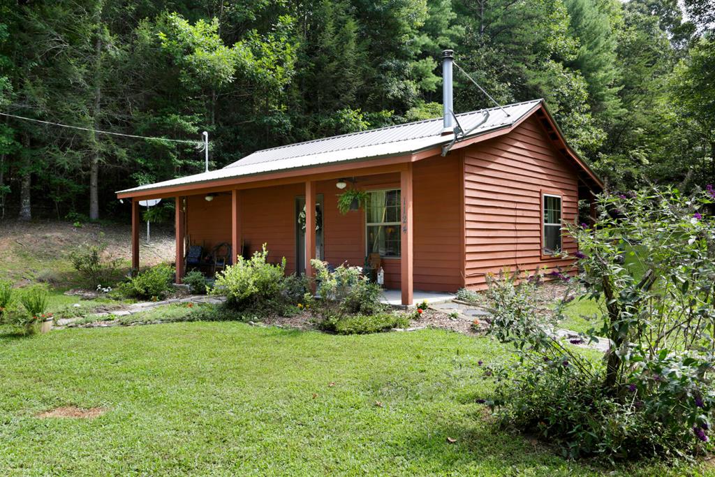 a front view of house with a garden