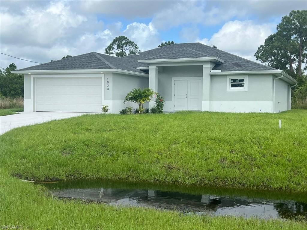 a front view of a house with a garden