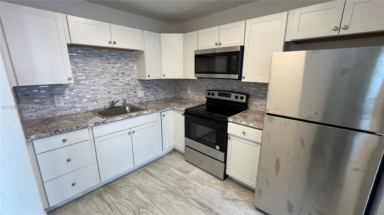 a white refrigerator freezer sitting inside of a kitchen