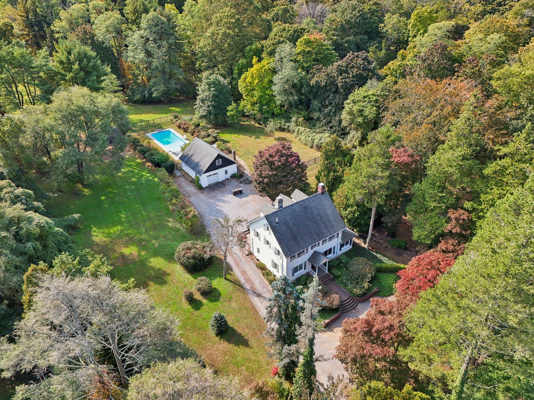 an aerial view of a house with a yard