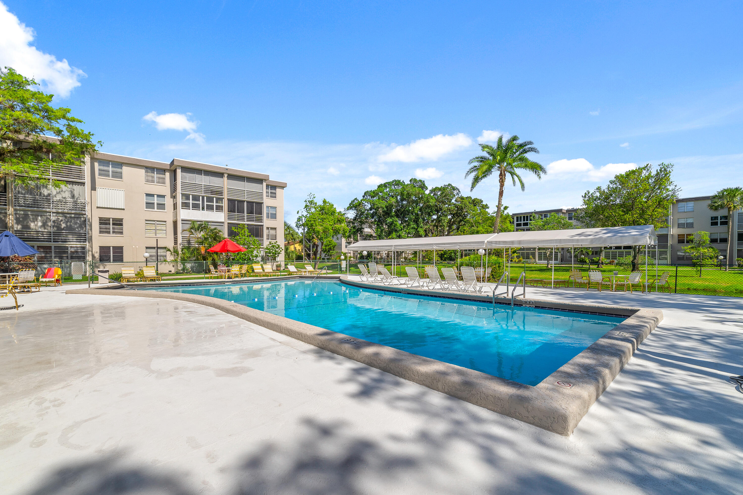 a view of swimming pool with outdoor seating and plants