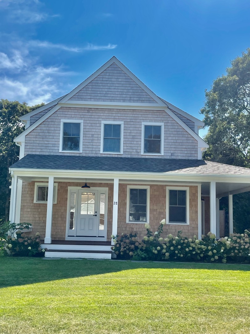 a front view of house with yard and green space