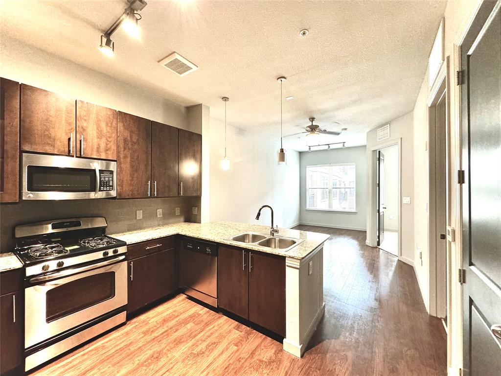 a kitchen with a sink stove and microwave