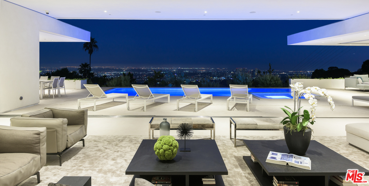 a living room with furniture and a kitchen view