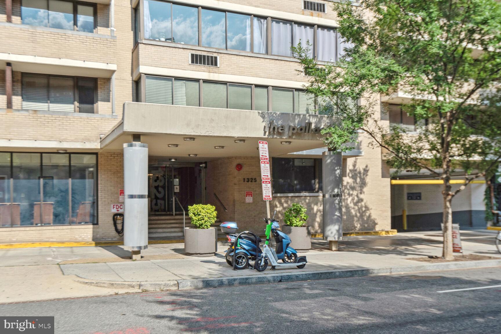 a front view of a building with sitting area