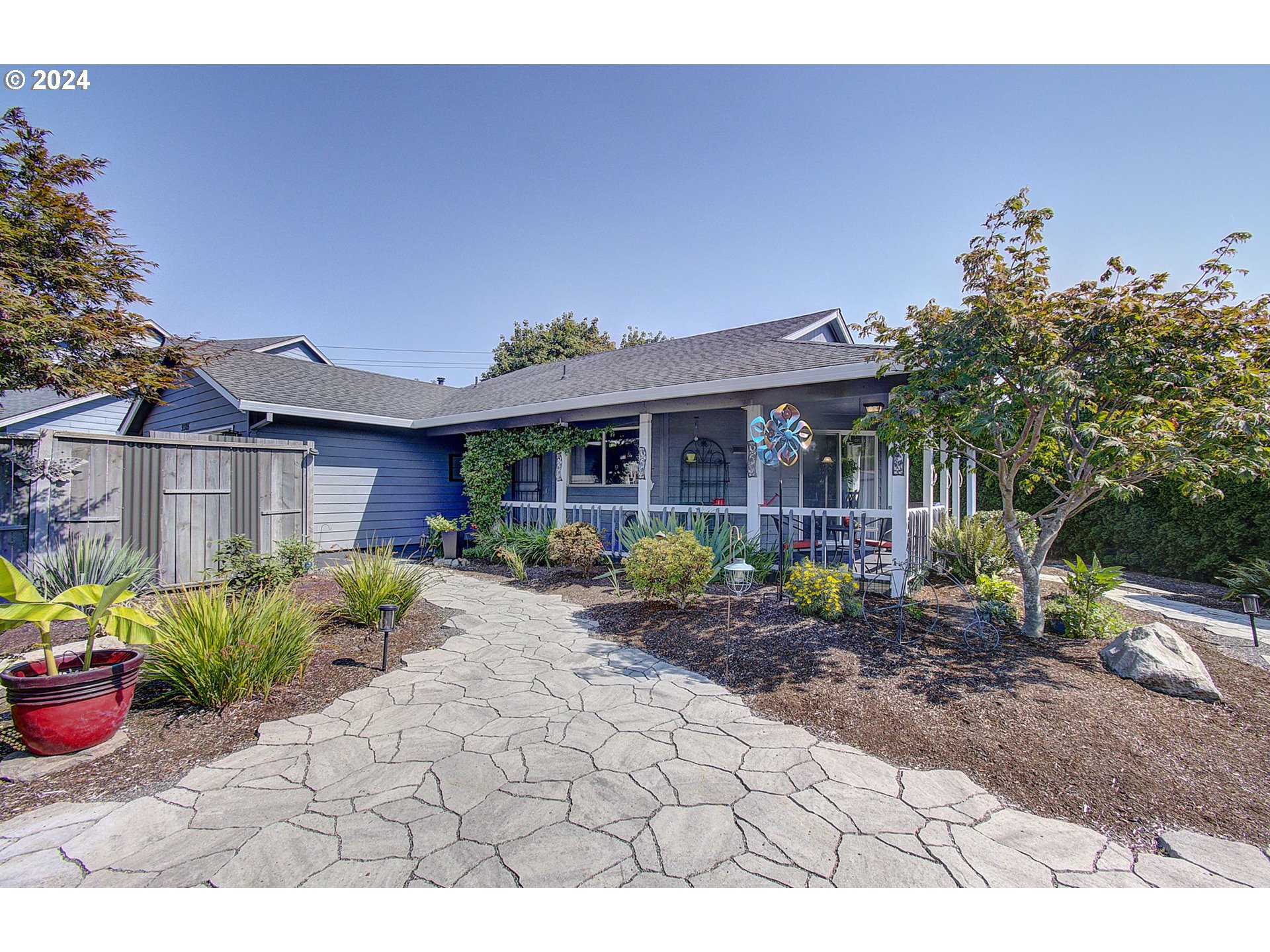 a front view of a house with a garden