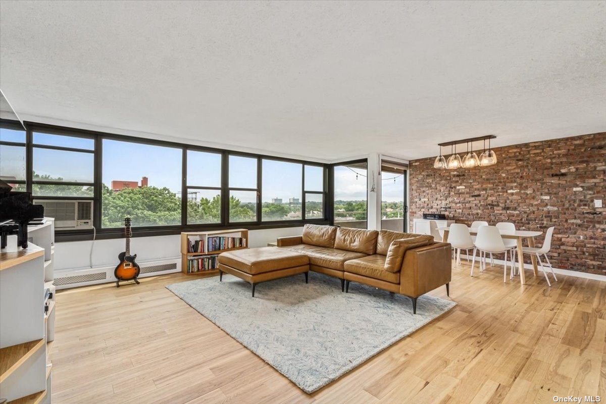 a living room with furniture large window and a table