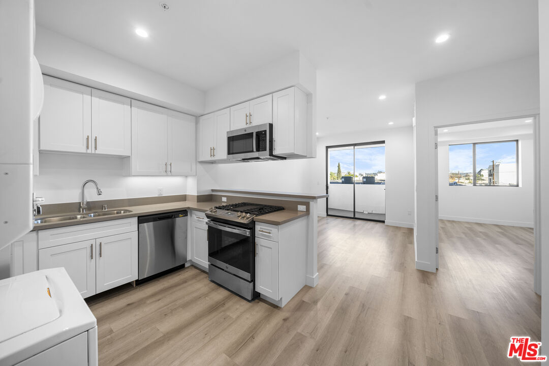 a kitchen with granite countertop a stove top oven and sink