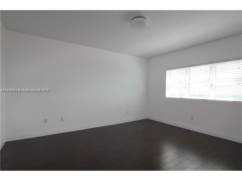 a view of an empty room and a window