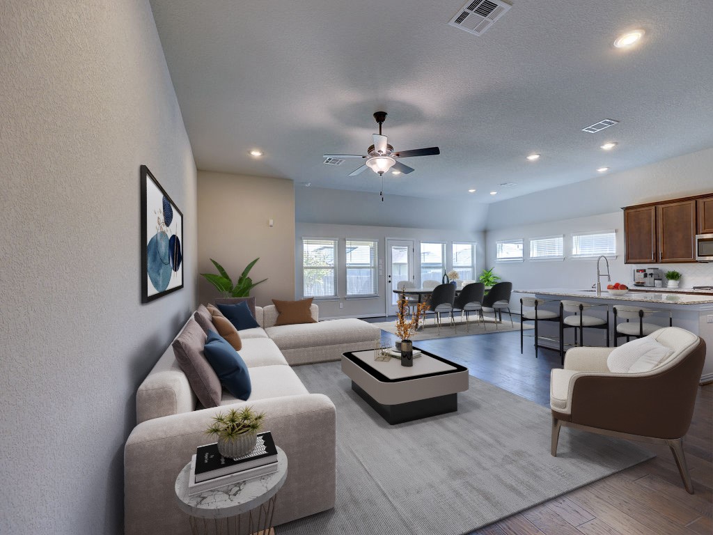 a living room with furniture and a view of kitchen