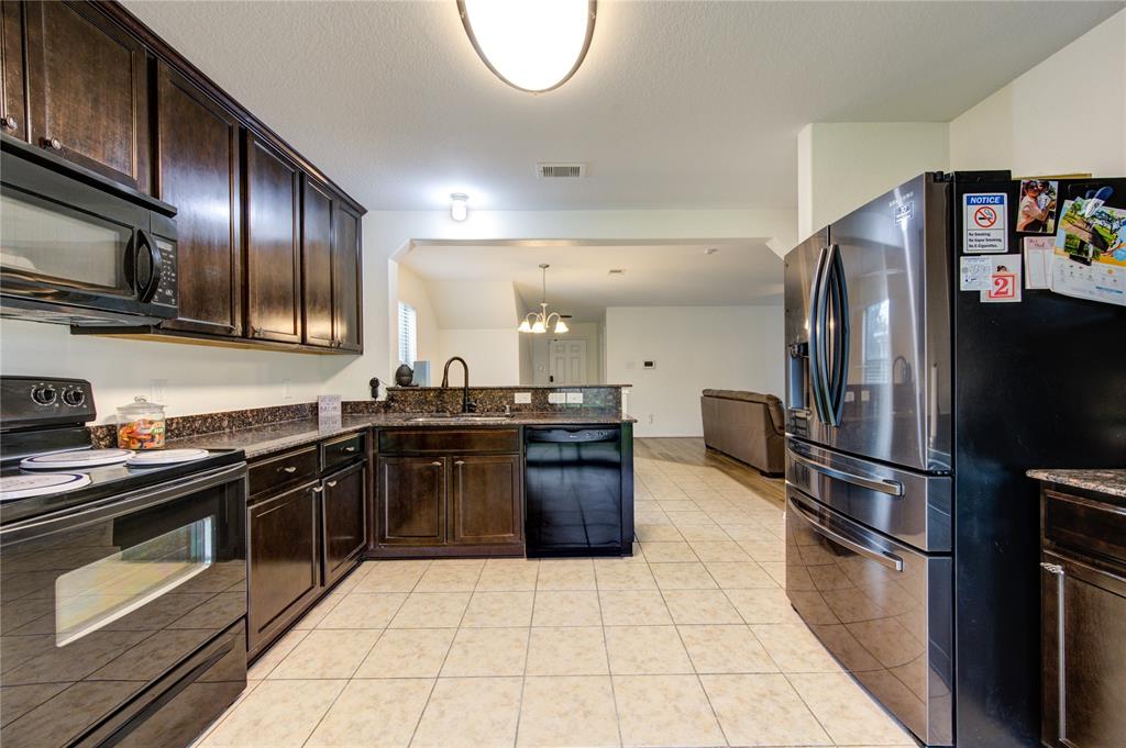 a kitchen with granite countertop stainless steel appliances and a sink