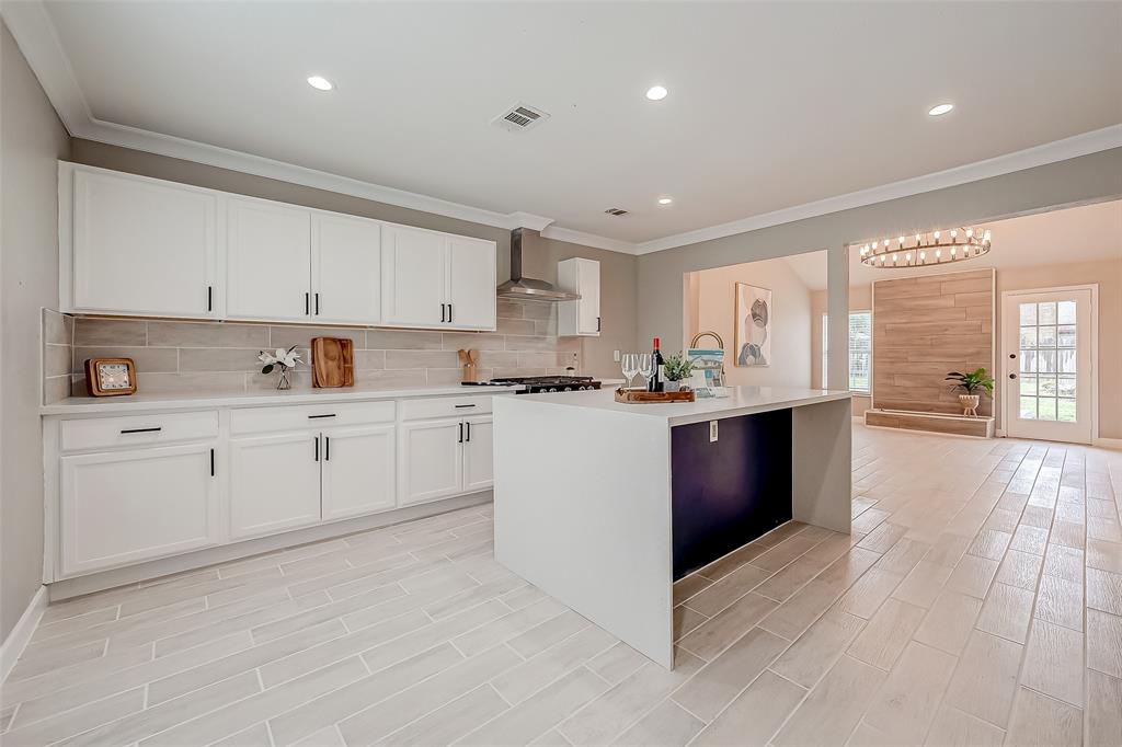 a kitchen with stainless steel appliances granite countertop a stove a sink dishwasher and a refrigerator