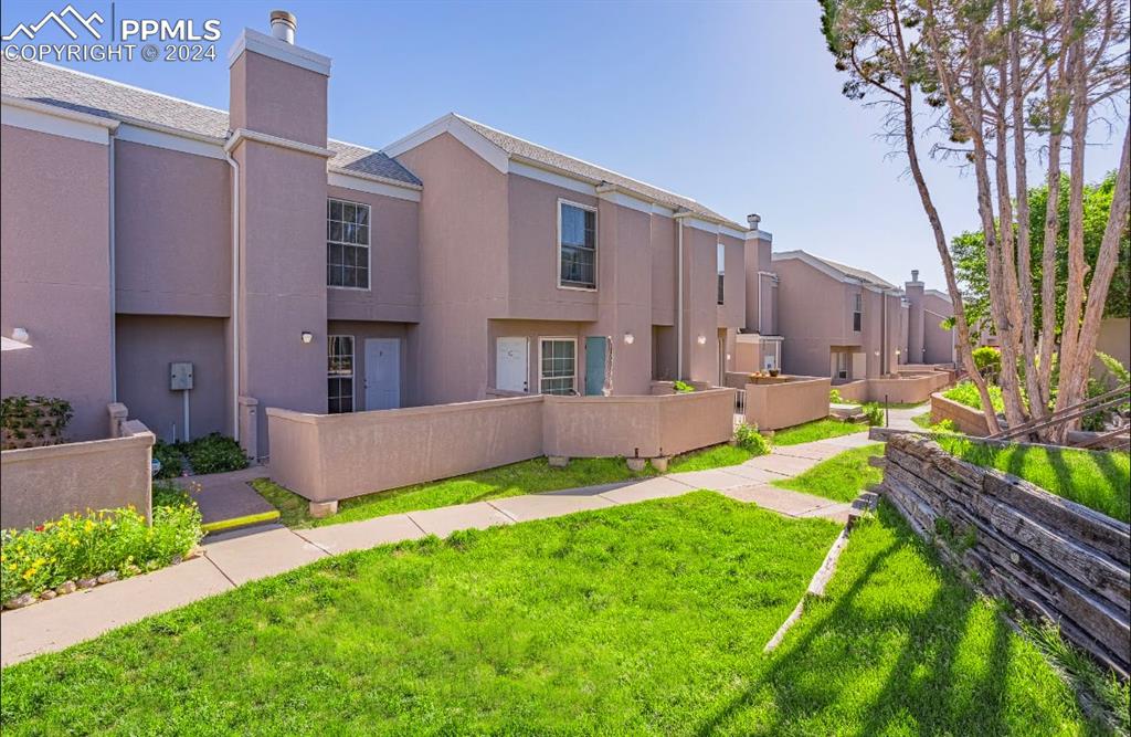 View of home's community featuring a lawn