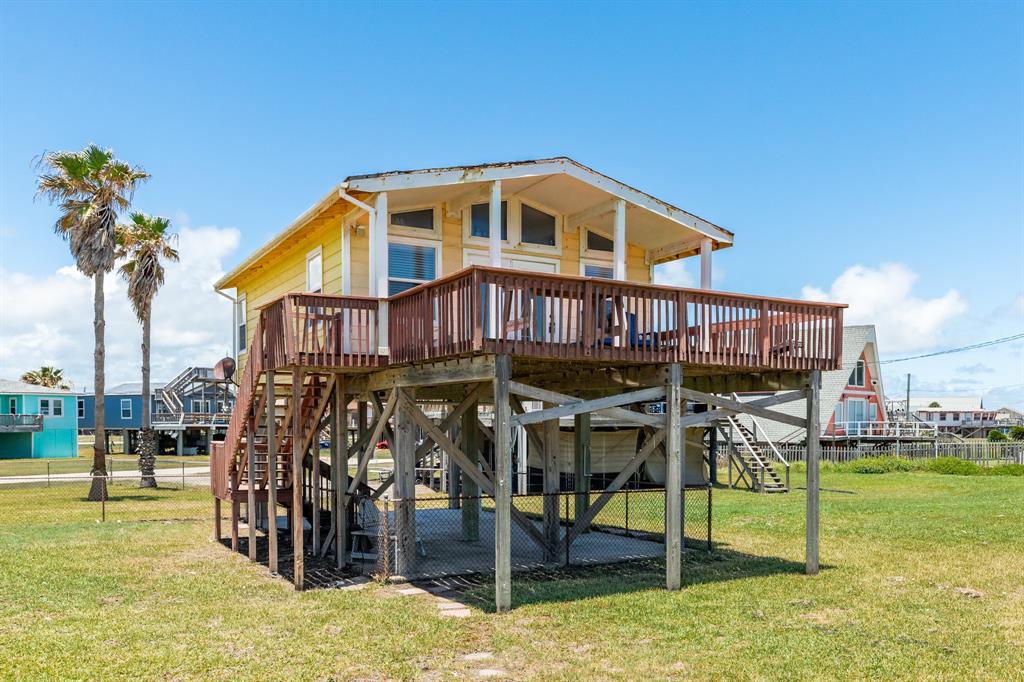 a view of a house with backyard porch and sitting area