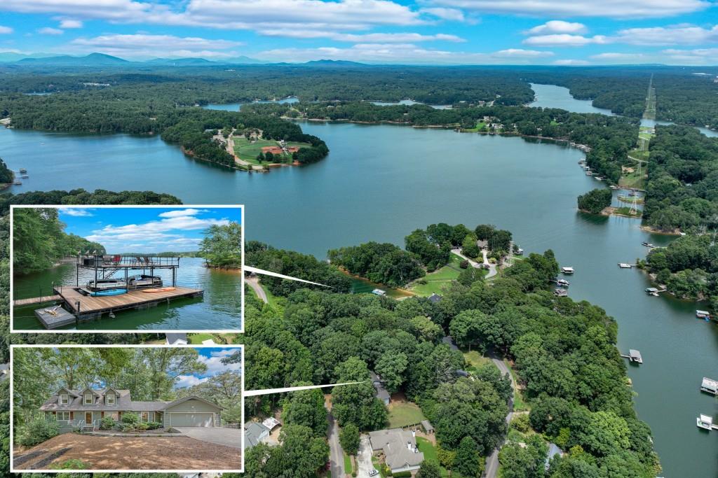 an aerial view of residential houses with outdoor space and lake