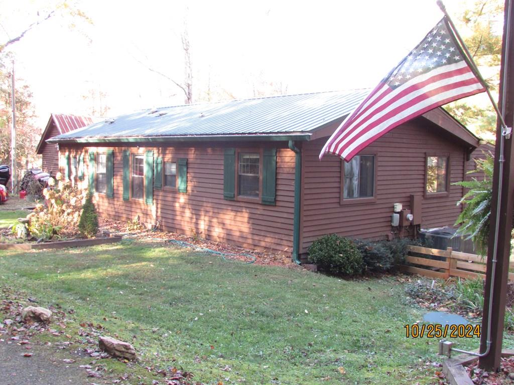 a front view of a house with a garden and yard