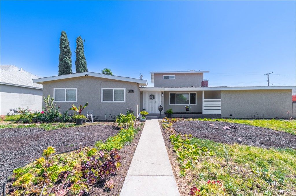 Large front yard- off Glendora Ave. Ample parking spaces on street. Expediently landscaped with drought tolerant ground covers and succulents . Symbolic shapes of Circle (HARMONY) & heart (LOVE).