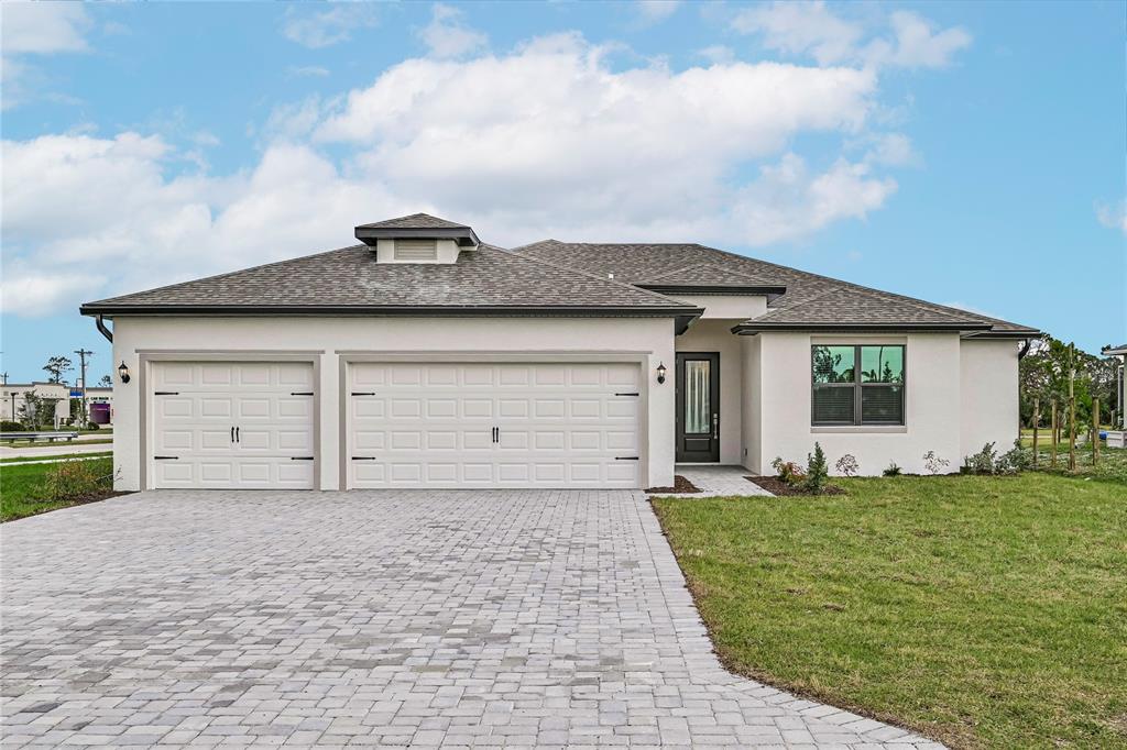 a view of a house with a yard and garage